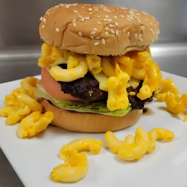 A Bubba's Bistro burger with a beef patty, lettuce, tomato, and mac and cheese.